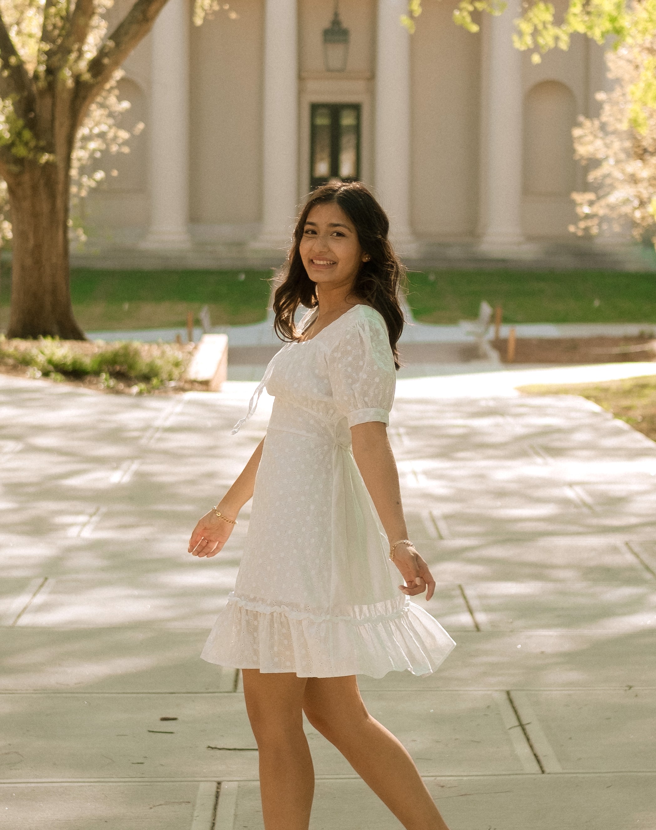Picture of Himani in a white dress on UGA's campus